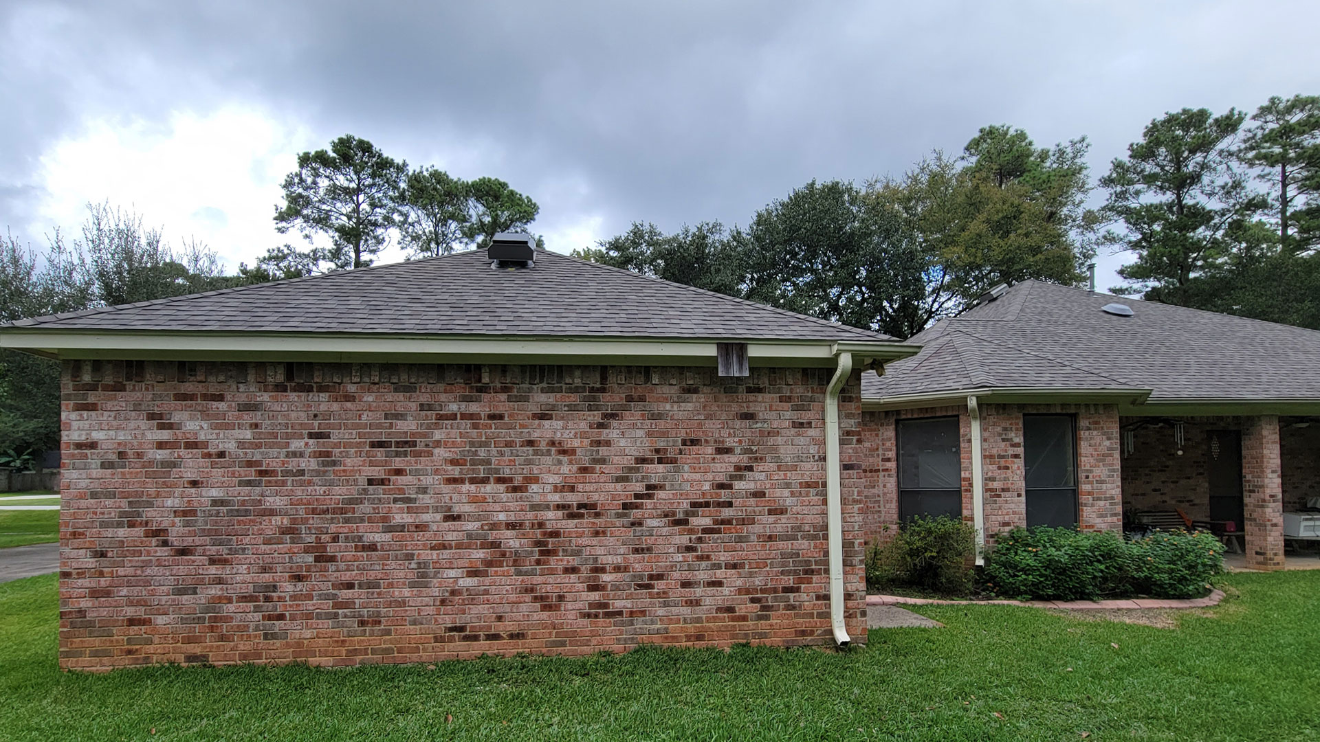 A rear view of the roofing job upon completion. Certainteed's ClimateFlex® - Colored in weathered wood. And Shadow Ridge® plus Solar Power Attic Vents installed in Tomball, Texas (a city between Cypress and Spring in Northern Houston).