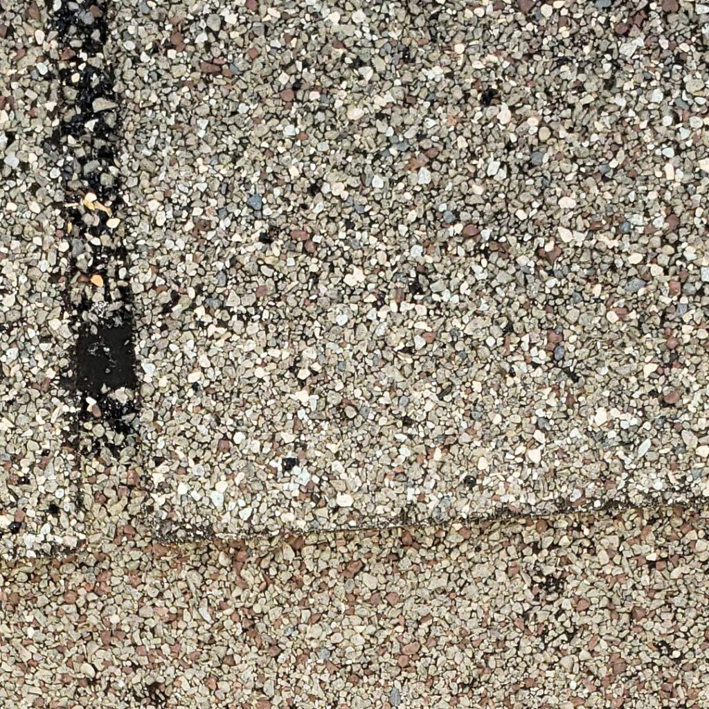 shingle granules loss due to hailstorms seen during inspection in jersey village texas